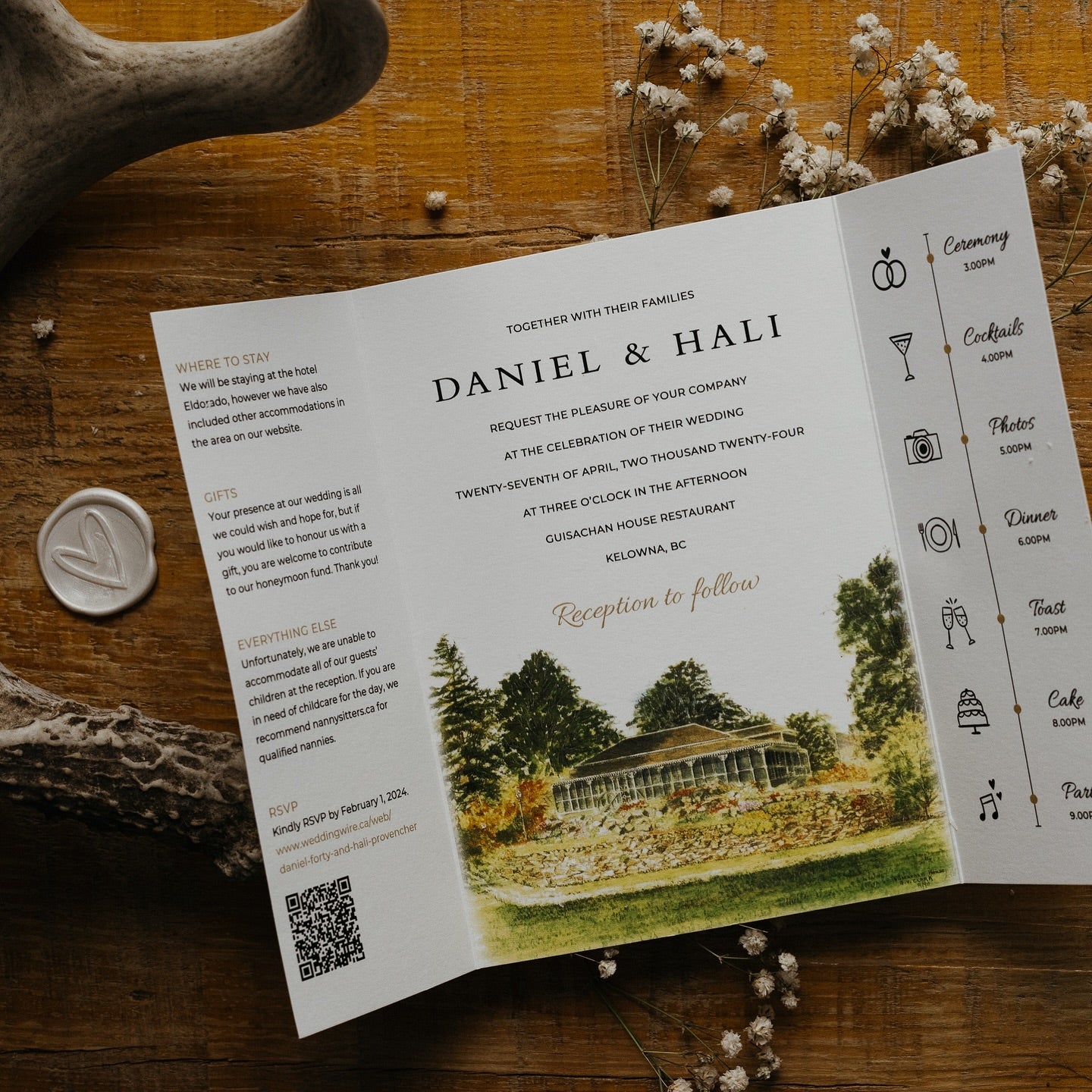 Gatefold wedding invitation featuring a hand-painted venue sketch, timeline icons, and detailed guest information, styled on rustic wood with wax seal.