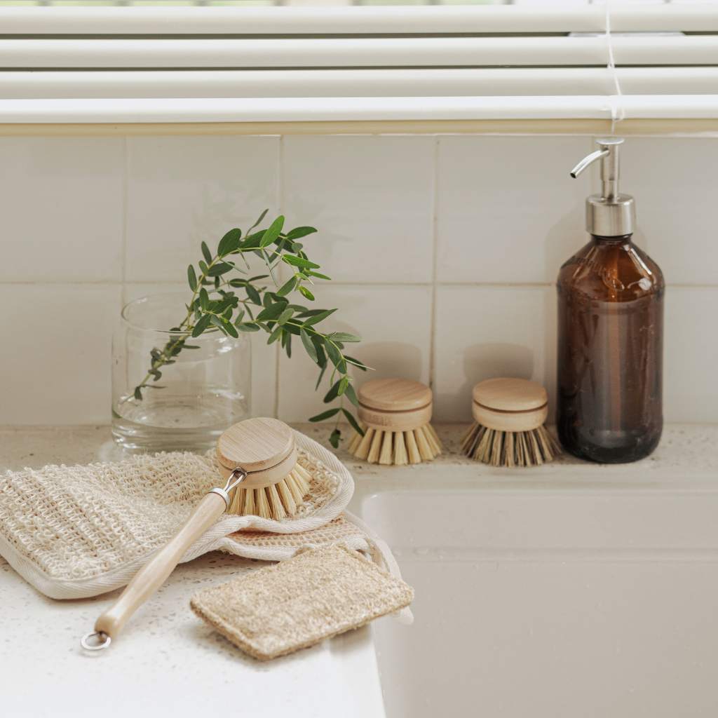 Bamboo kitchen brush set with long handle, refill heads and loofah on ceramic sink lifestyle photo