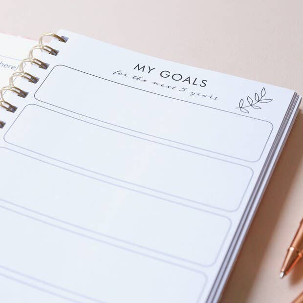 Open guided journal pages showing mindfulness and gratitude prompts