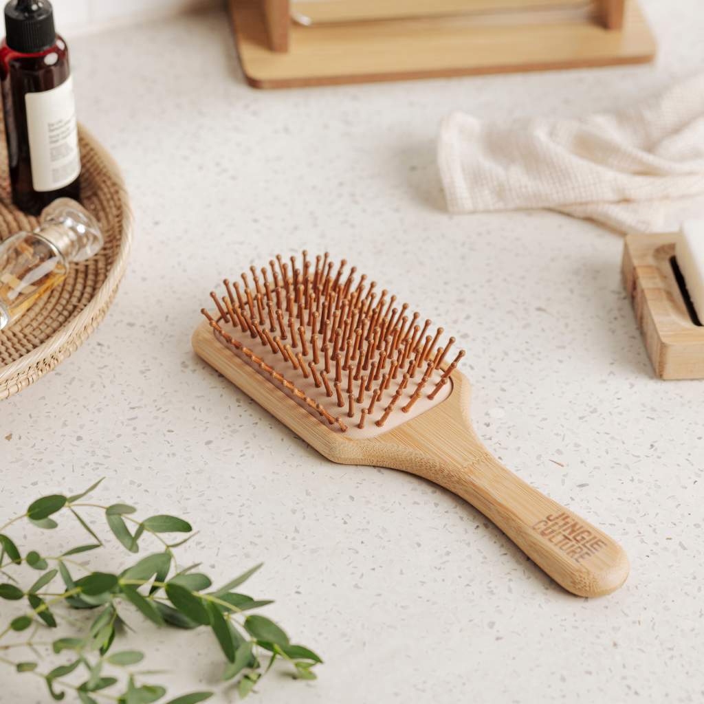 Close-up of natural bamboo bristles on eco-friendly hairbrush on bathroom surface