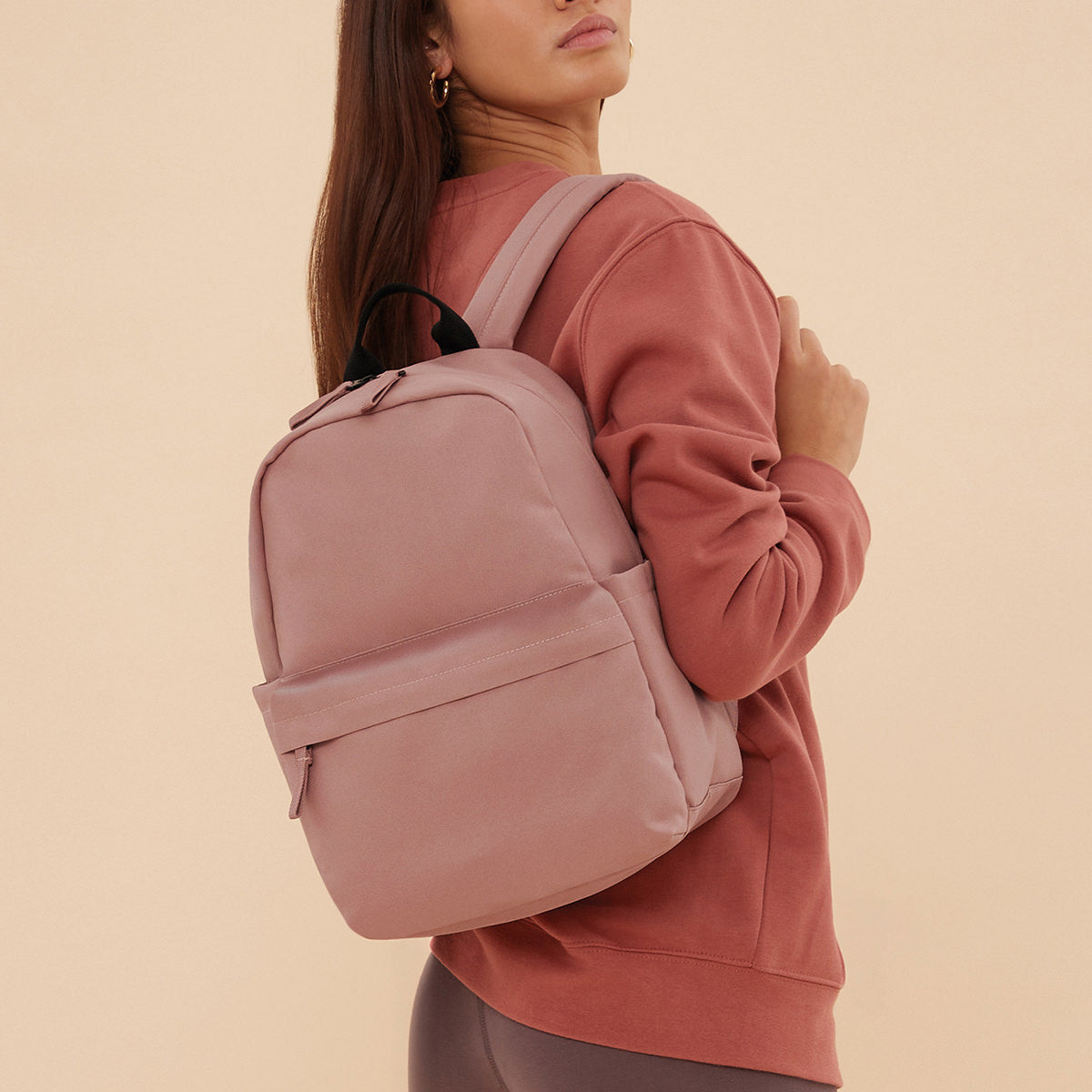 Compact everyday mini backpack in pink colour with zip pocket
