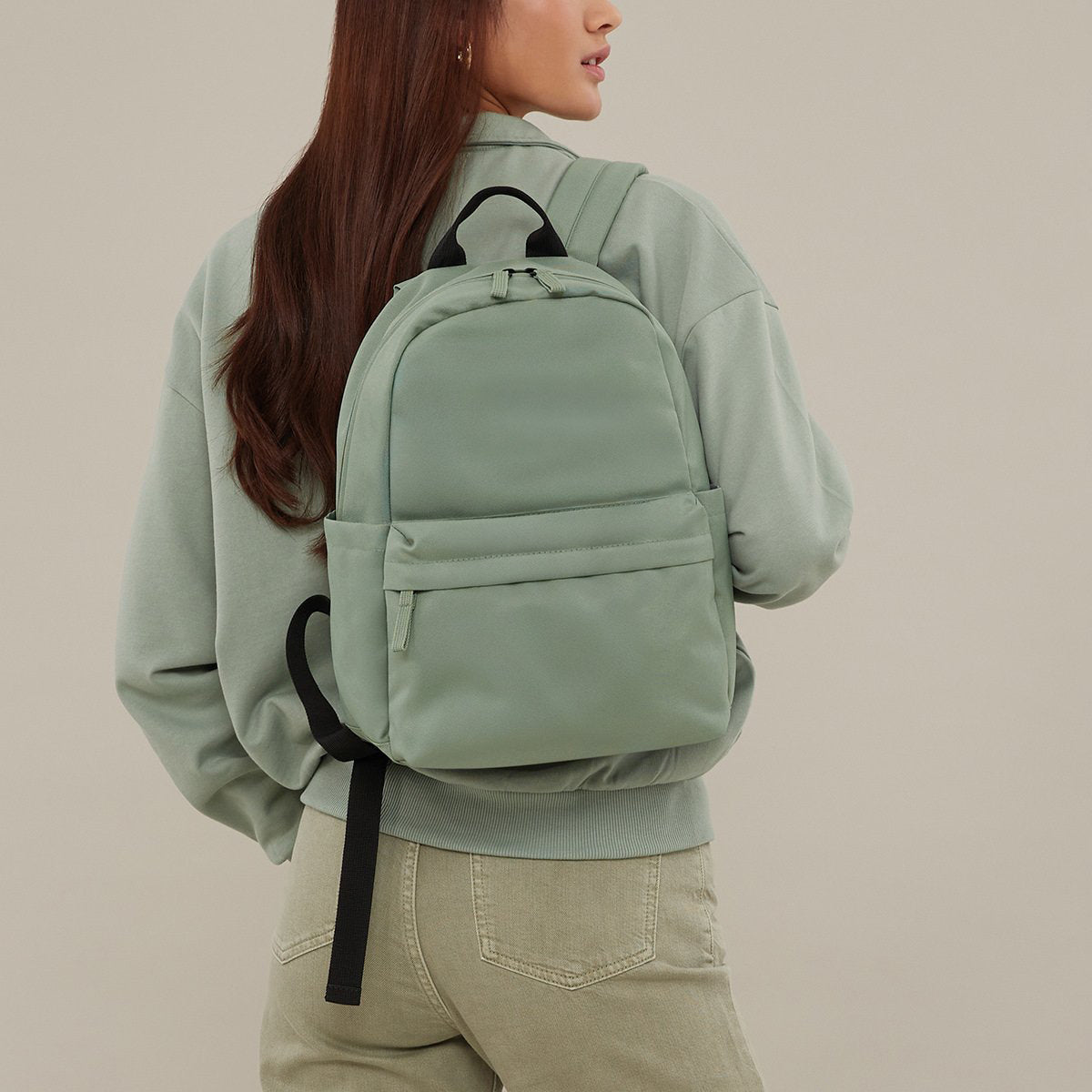 Compact everyday mini backpack in green colour with zip pocket