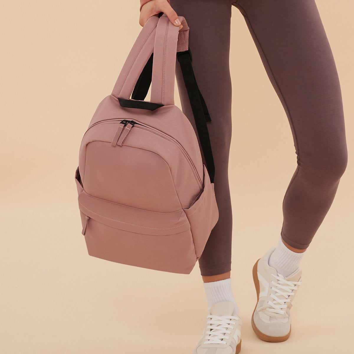 Compact everyday mini backpack in neutral colour with zip pocket
