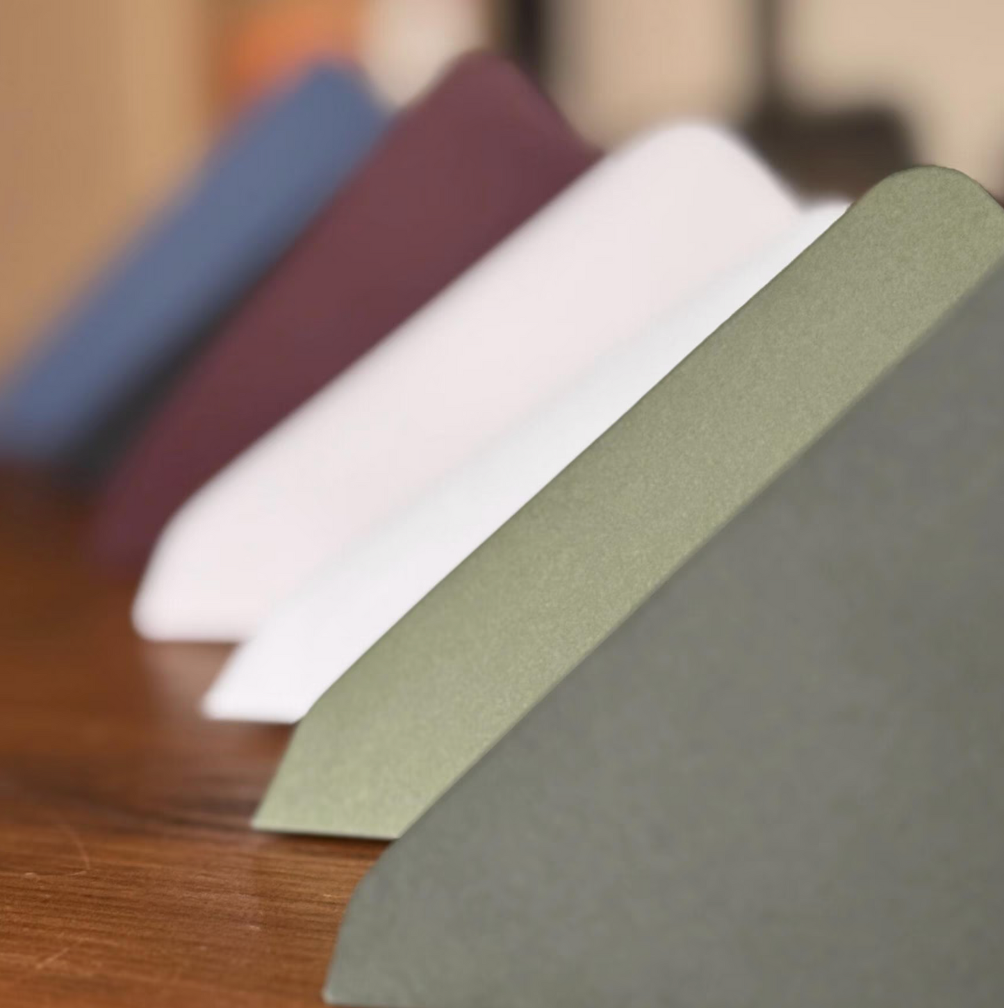Color swatches of fabric in various colors on a wooden surface