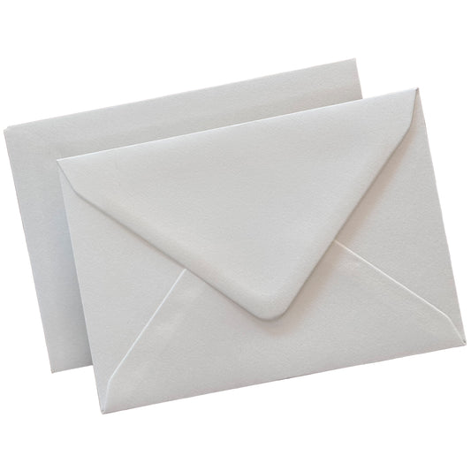 white envelopes flat lay against isolate white background, showing the diamond flap envelopes from the front and the reverse.