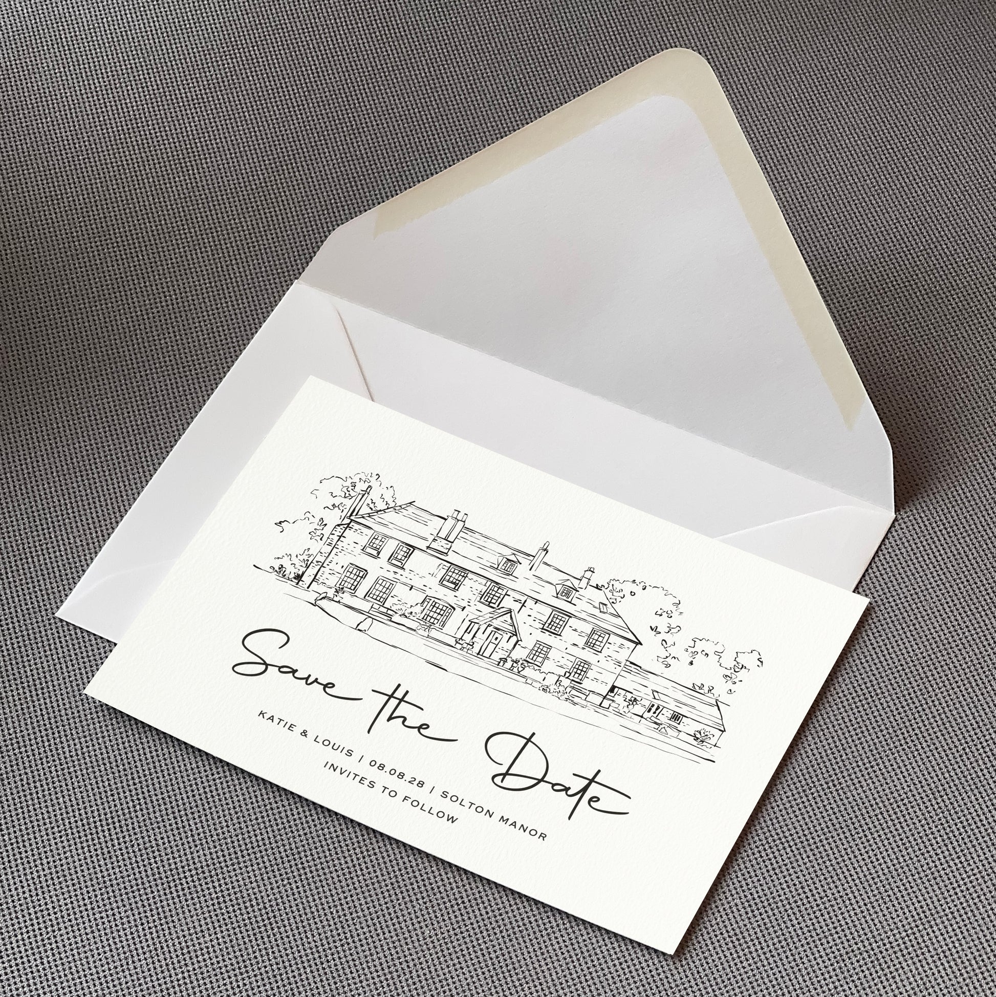 a save the date card sat on top of an envelope on a table