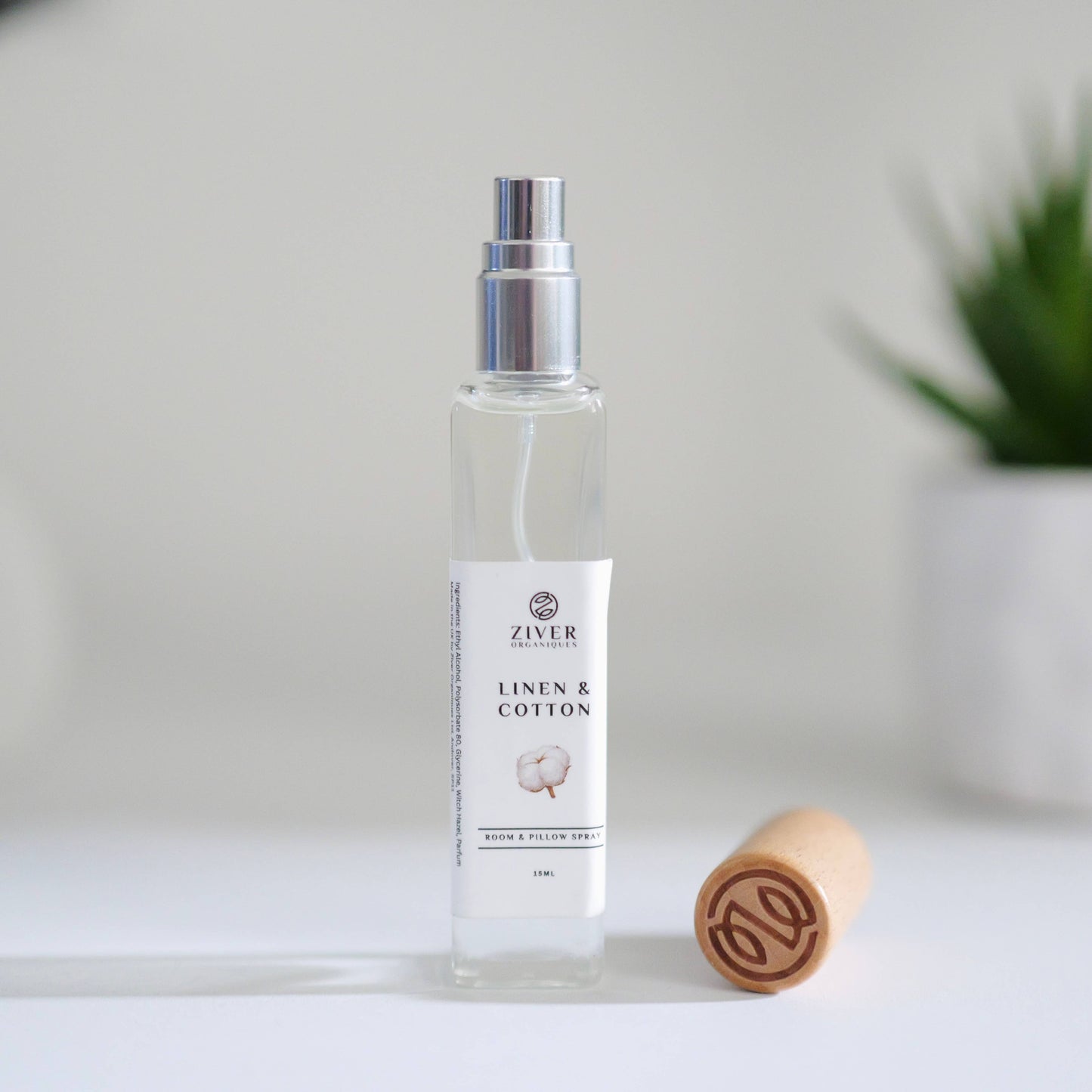 Fresh Linen room spray in glass bottle with soft towels in background