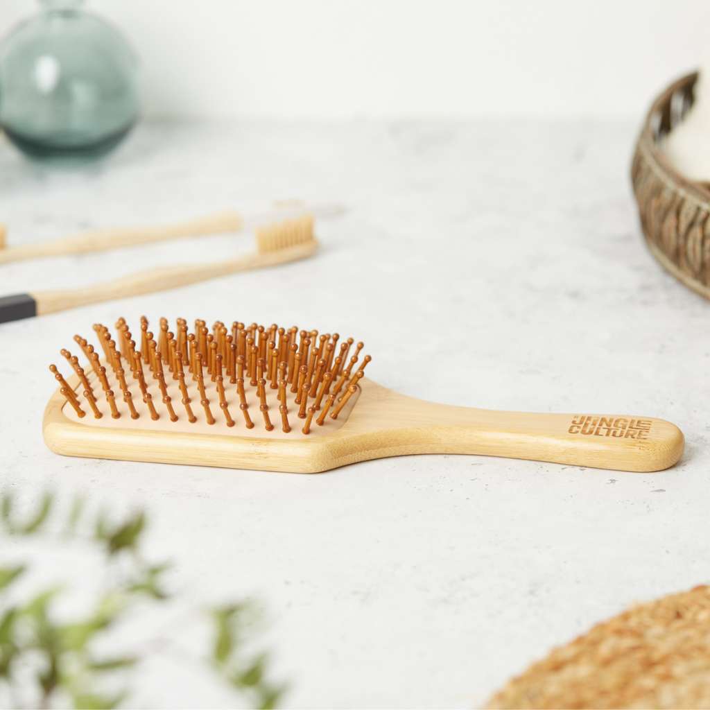 Close-up of natural bamboo bristles on eco-friendly hairbrush with grooming utensils