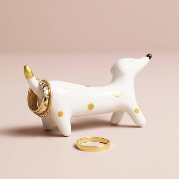 Close-up of glossy ceramic dachshund with gold detailing