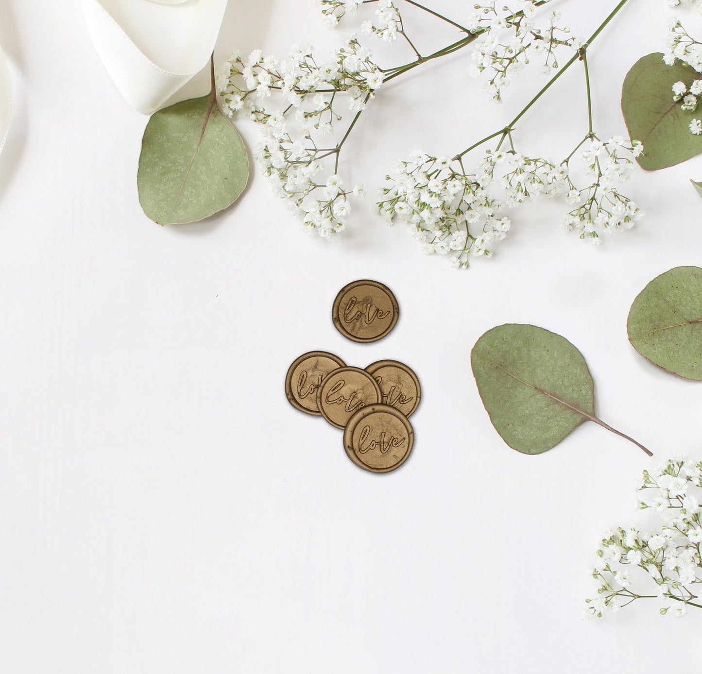 Love Gold Wax Seals on white background with baby's breath florals and leaves