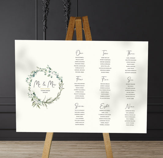 olive leaves wedding Table Plan on a brown easel in a stylish room in a wedding venue