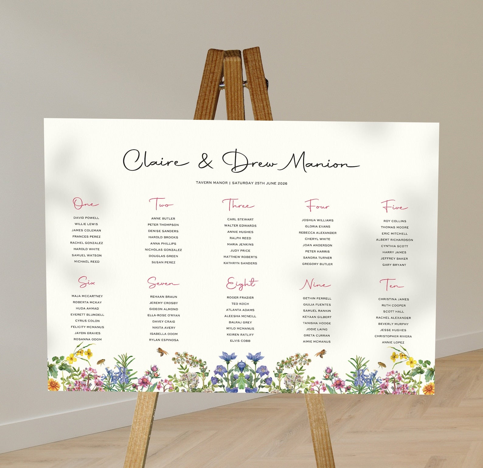 spring florals wedding Table Plan on a brown easel in a stylish room in a wedding venue