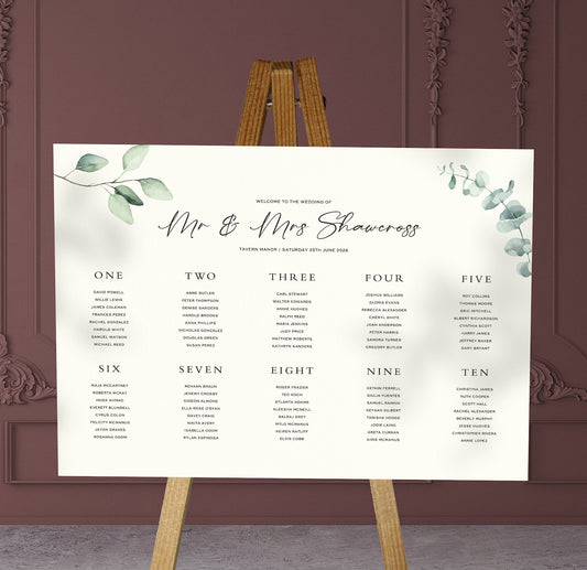 eucalyptus leaves wedding Table Plan on a brown easel in a stylish room in a wedding venue