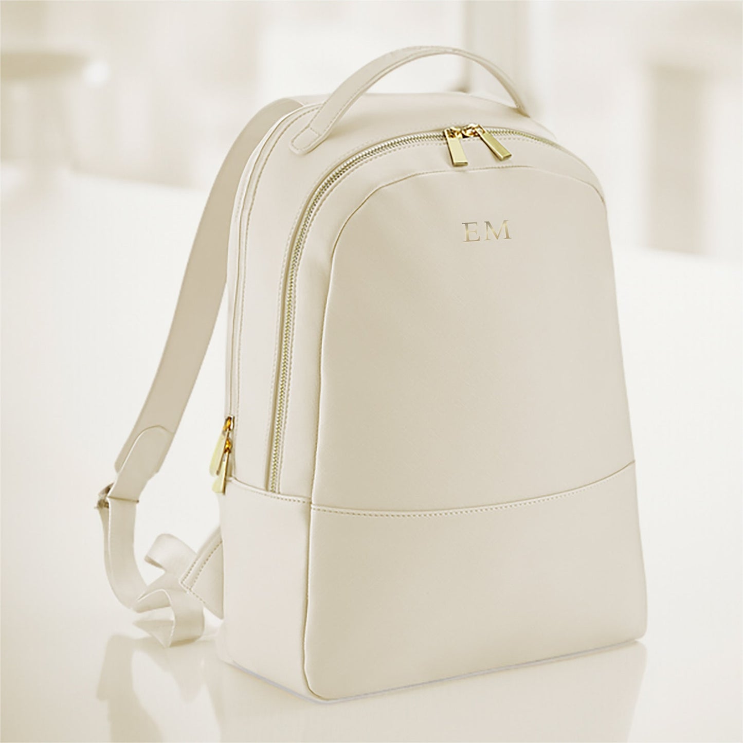 Modern oyster faux leather laptop backpack displayed on work desk