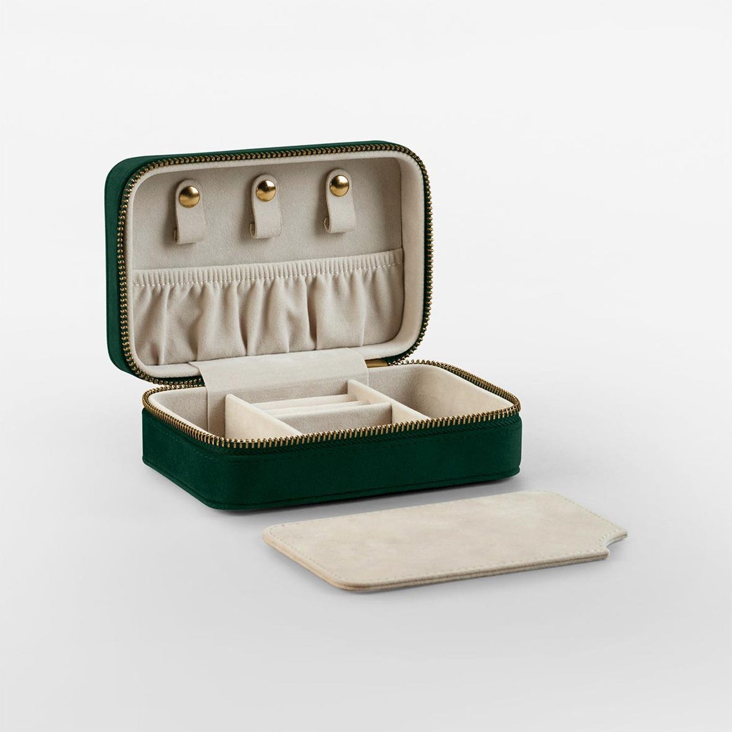 Flat lay of accessories with velvet jewellery case in green