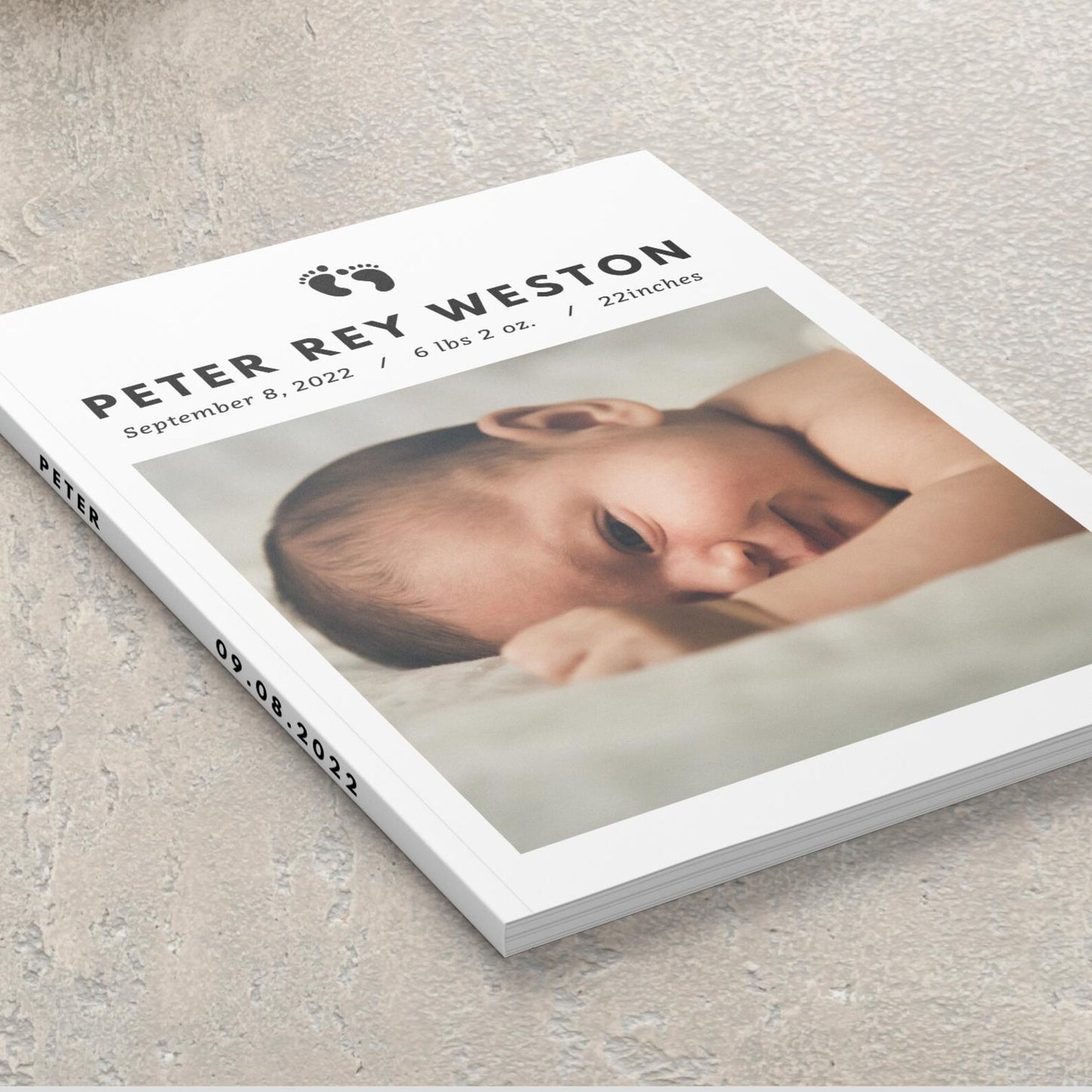 Hardcover personalised baby photo album closed on coffee table with baby photo displayed