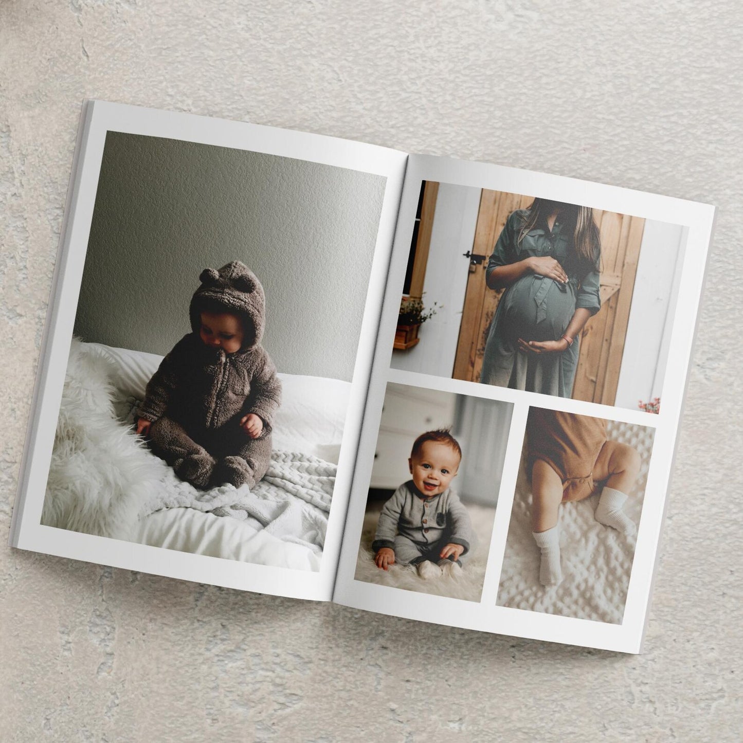 Hardcover personalised baby photo album open on coffee table with baby photos displayed
