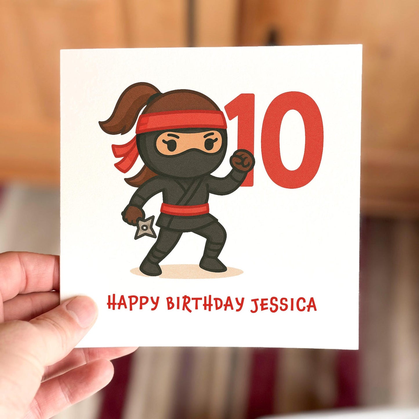 Children’s birthday card featuring a cartoon ninja with a red headband and number ten, printed on textured white card.
