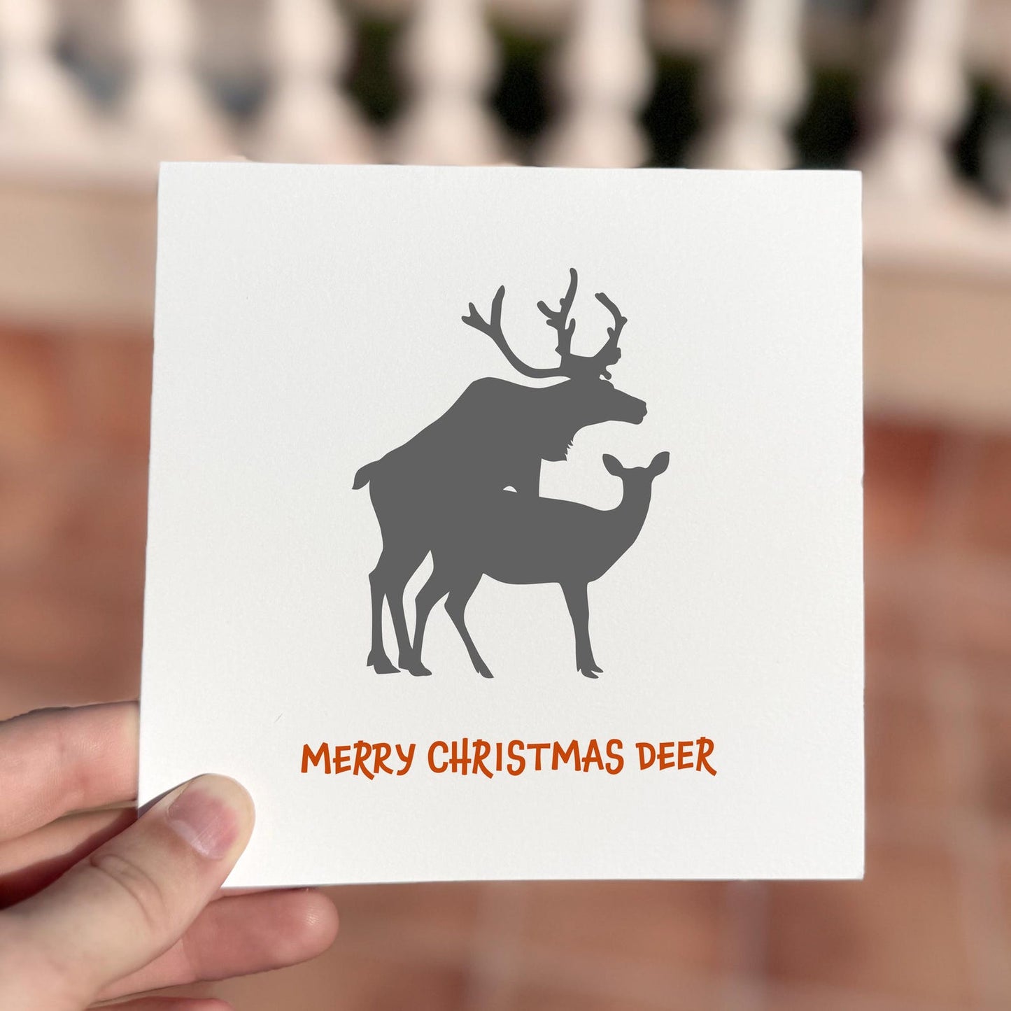 Funny Christmas card featuring two deer silhouettes and the phrase ‘Merry Christmas Deer’.