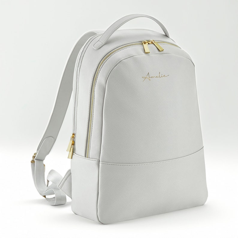 Backpack shown in grey with zipped front pocket and adjustable straps