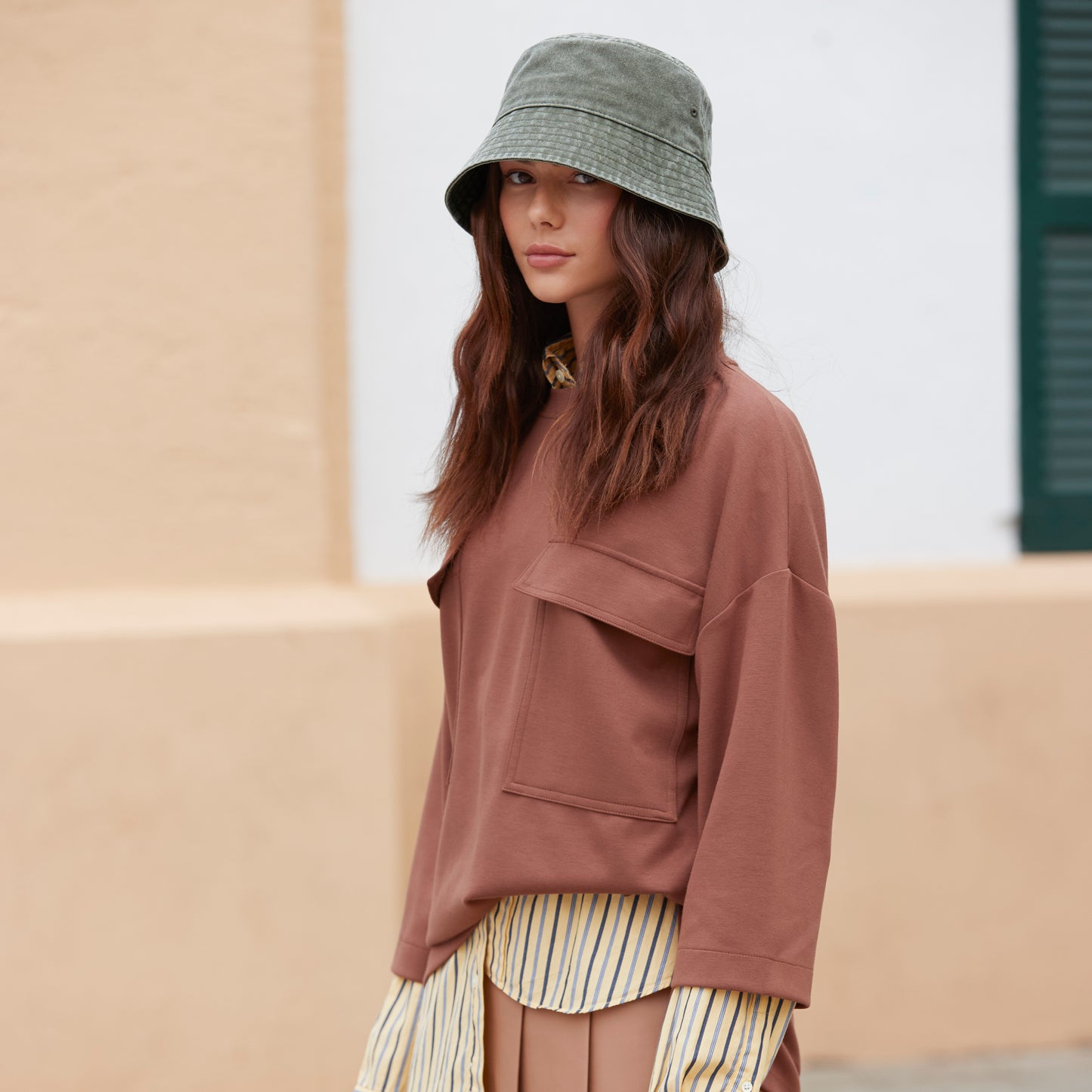 Model wearing cotton bucket hat outdoors
