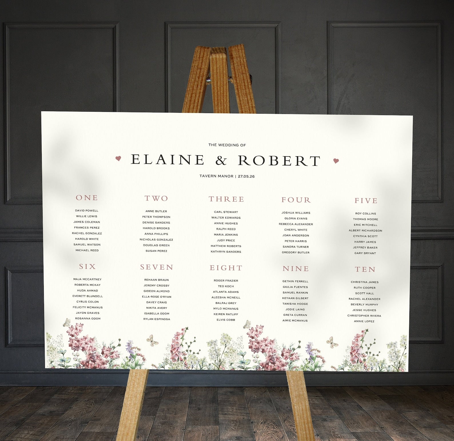 purple and sage wildflowers wedding Table Plan on a brown easel in a stylish room in a wedding venue