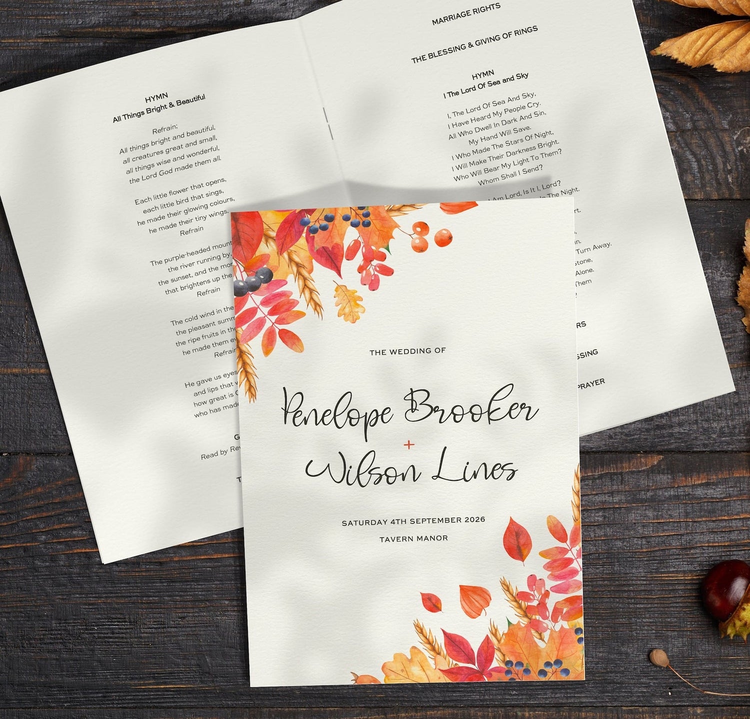 autumn order of service booklet on dark wooden table next to autumn leaves