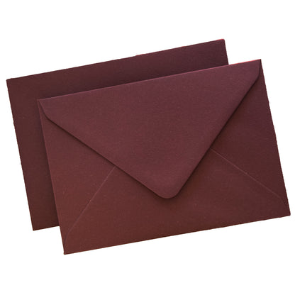 burgundy envelopes flat lay against isolate white background, showing the diamond flap envelopes from the front and the reverse.