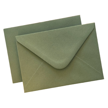 sage envelopes flat lay against isolate white background, showing the diamond flap envelopes from the front and the reverse.