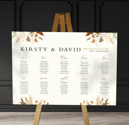 brown florals  wedding Table Plan on a brown easel in a stylish room in a wedding venue