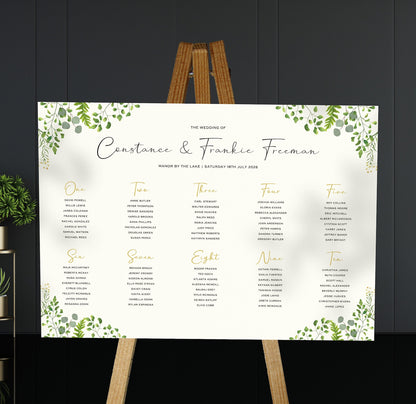 greenery wedding Table Plan on a brown easel in a stylish room in a wedding venue