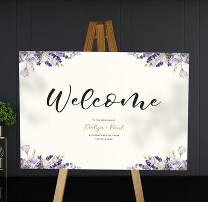 purple lavender A1 welcome sign board on a brown easel in a wedding venue room with stylish decor