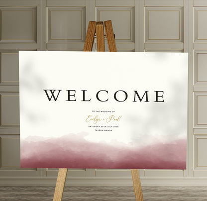 burgundy watercolour A1 welcome sign board on a brown easel in a wedding venue room with stylish decor