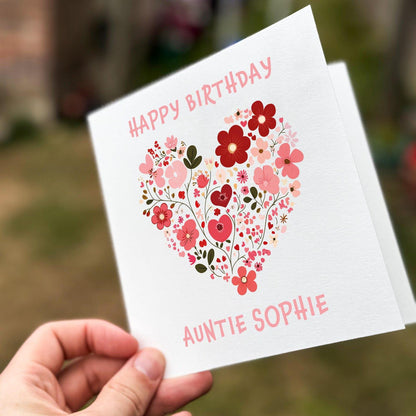 Square white card with a pink and red floral heart design and text reading ‘Happy Birthday Auntie’, printed on textured card.