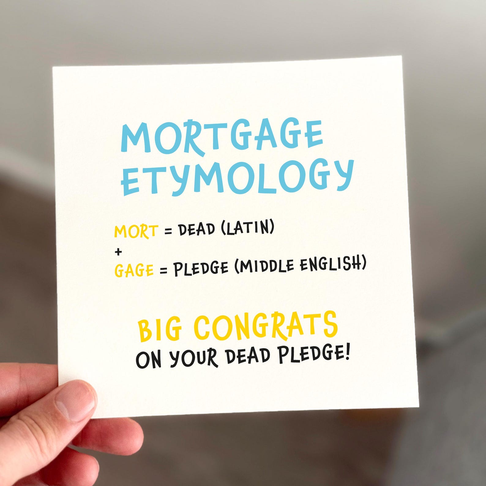 Funny mortgage card with blue and yellow text explaining the meaning of ‘mortgage’ and congratulating the recipient.
