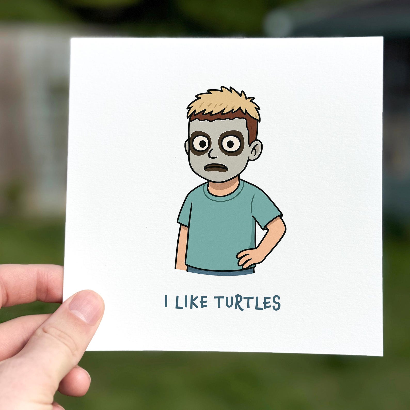 Funny greeting card showing a cartoon boy with face paint and the text ‘I like turtles’.