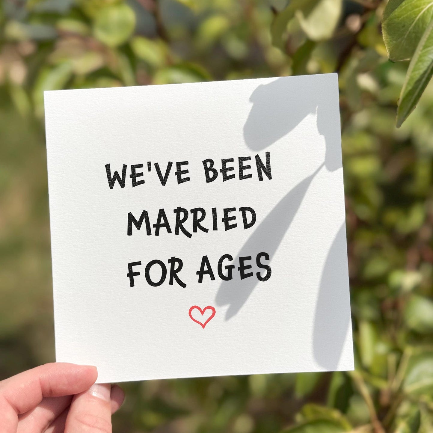 Funny anniversary card with the phrase ‘We’ve Been Married For Ages’ and a red heart illustration.