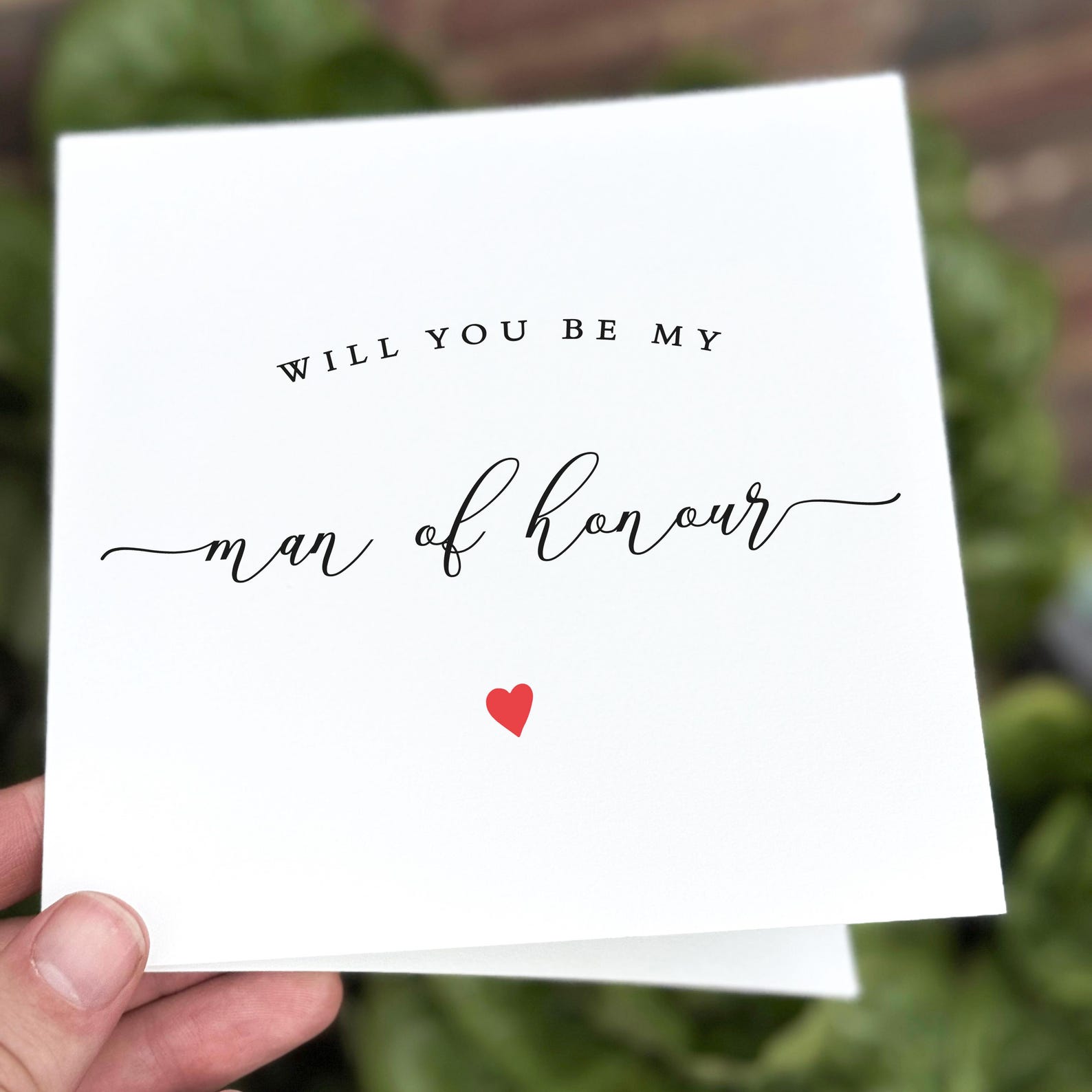 Man of honour proposal card with stylish typography and small red heart illustration.