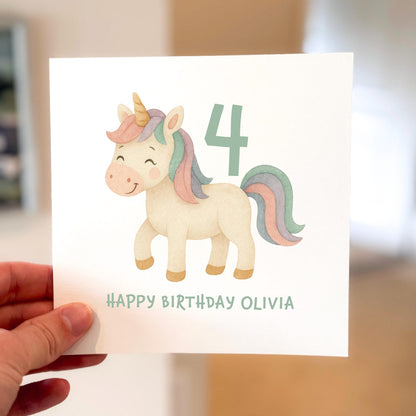 Pastel unicorn birthday card with rainbow mane and number 4, text reads ‘Happy Birthday’.