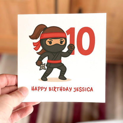Children’s birthday card featuring a cartoon ninja with a red headband and number ten, printed on textured white card.