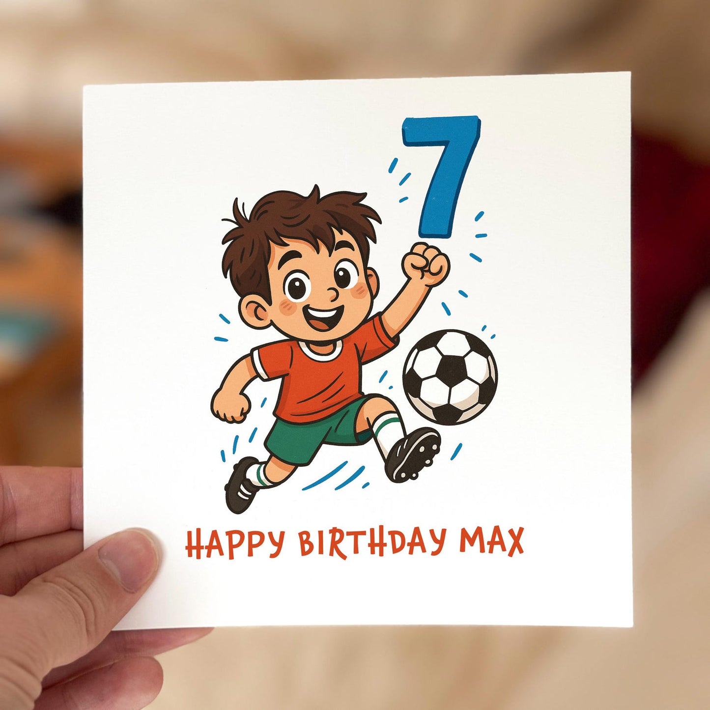 Birthday card featuring a cartoon boy in a red shirt kicking a football with a large blue number seven, printed on textured white card.