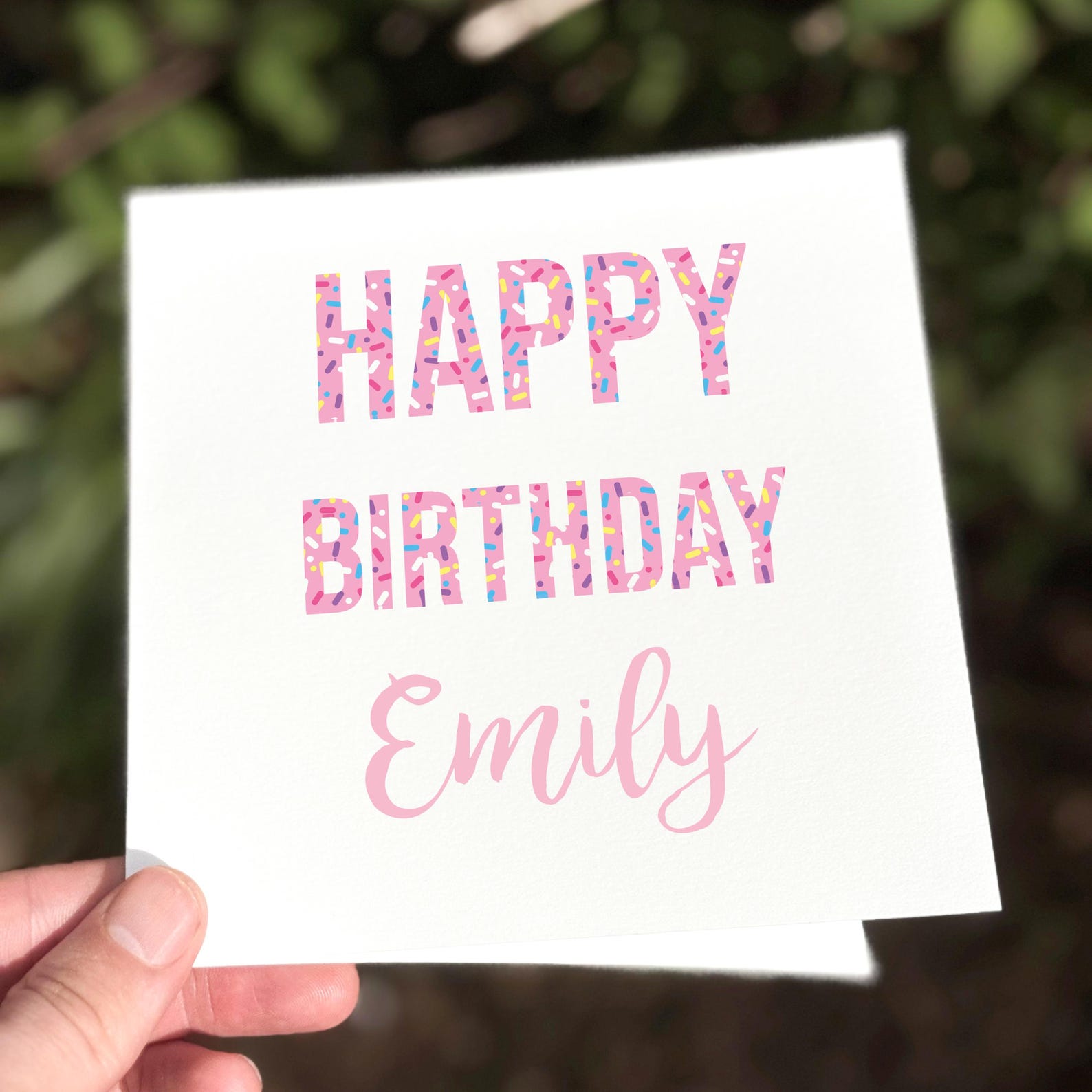White square card with bold pink confetti letters reading ‘Happy Birthday’ and space for personalised name.