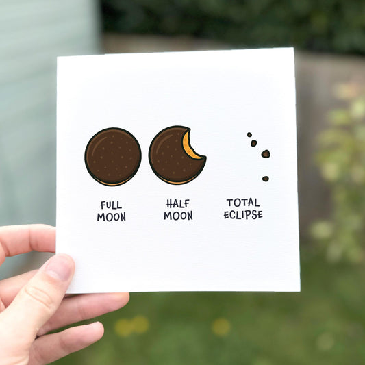 Funny card showing three chocolate biscuit illustrations labelled ‘Full moon’, ‘Half moon’, and ‘Total eclipse’.