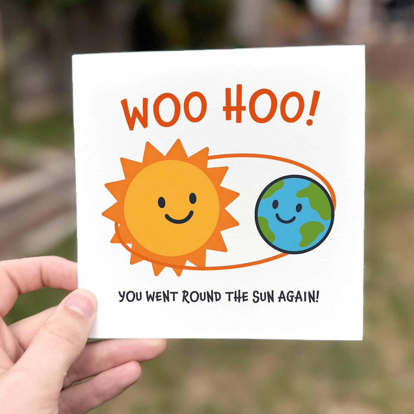Fun illustrated card showing a smiling sun and earth orbit with the text ‘Woo hoo! You went round the sun again!’.