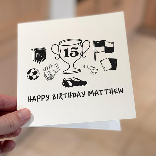 Football-themed birthday card showing a large trophy surrounded by football gloves, whistle and flag icons.