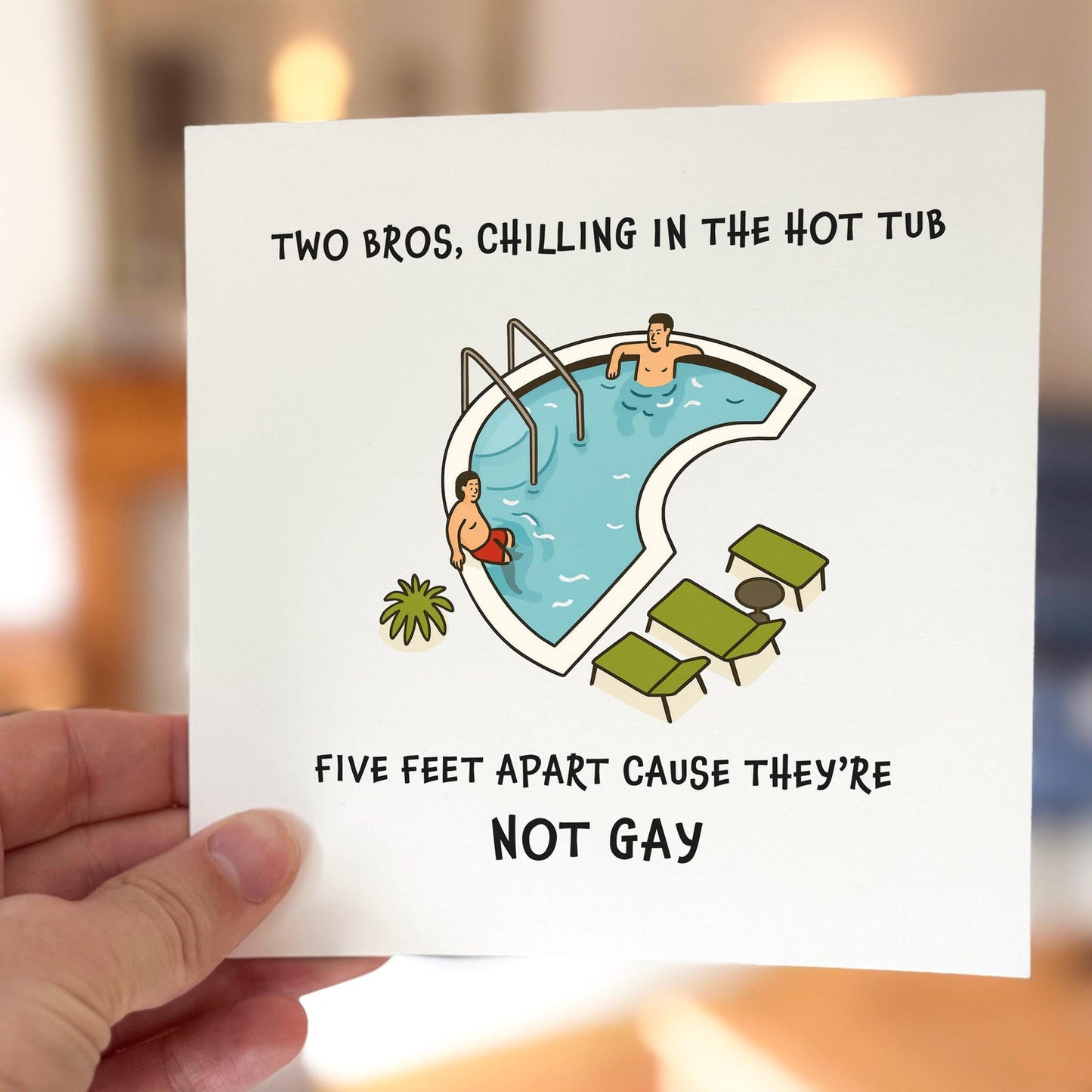 Funny meme card showing two men sitting in a hot tub five feet apart with the caption ‘Cause they’re not gay’.
