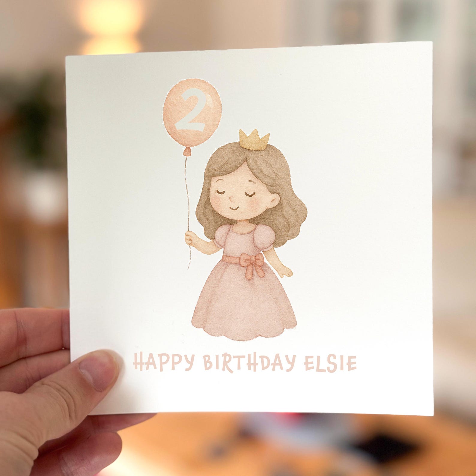 Birthday card featuring a pastel princess holding a number two balloon, printed on white textured card.