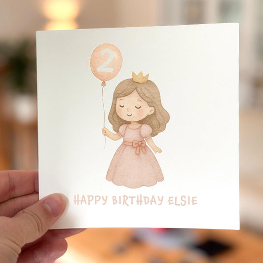 Birthday card featuring a pastel princess holding a number two balloon, printed on white textured card.