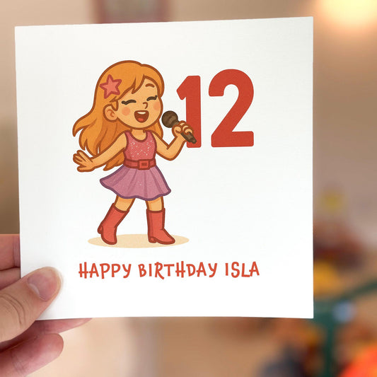 Birthday card featuring a cartoon girl singer holding a microphone with a red number twelve beside her.