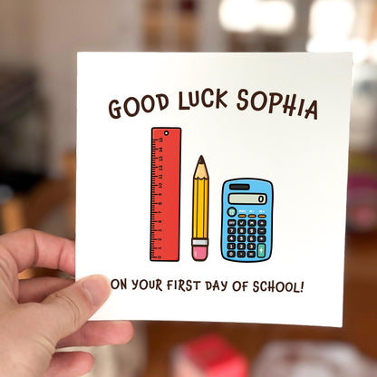 Good luck card featuring a ruler, pencil and calculator illustration with the text ‘First Day Of School’.